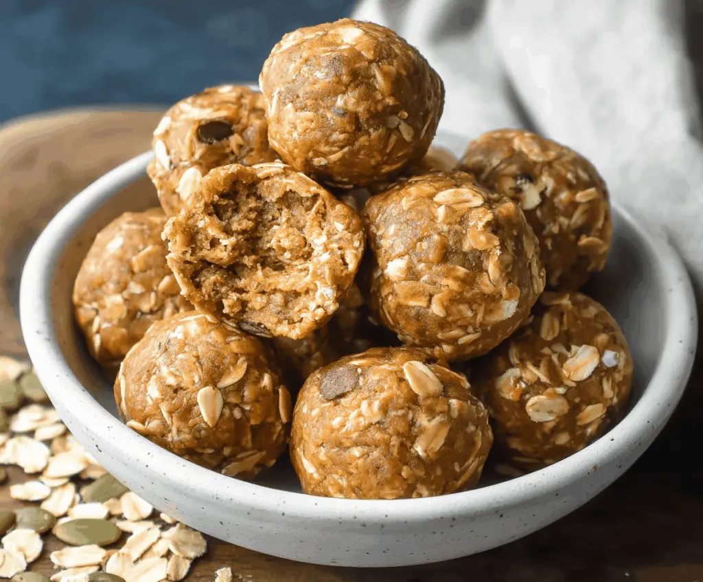 Delicious oatmeal pumpkin protein balls on a white plate, topped with chia seeds and cinnamon, healthy homemade snack option