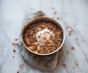Delicious Rose Water Apple Crisp topped with golden brown crust and fresh apple slices, perfect for a fragrant and comforting dessert.