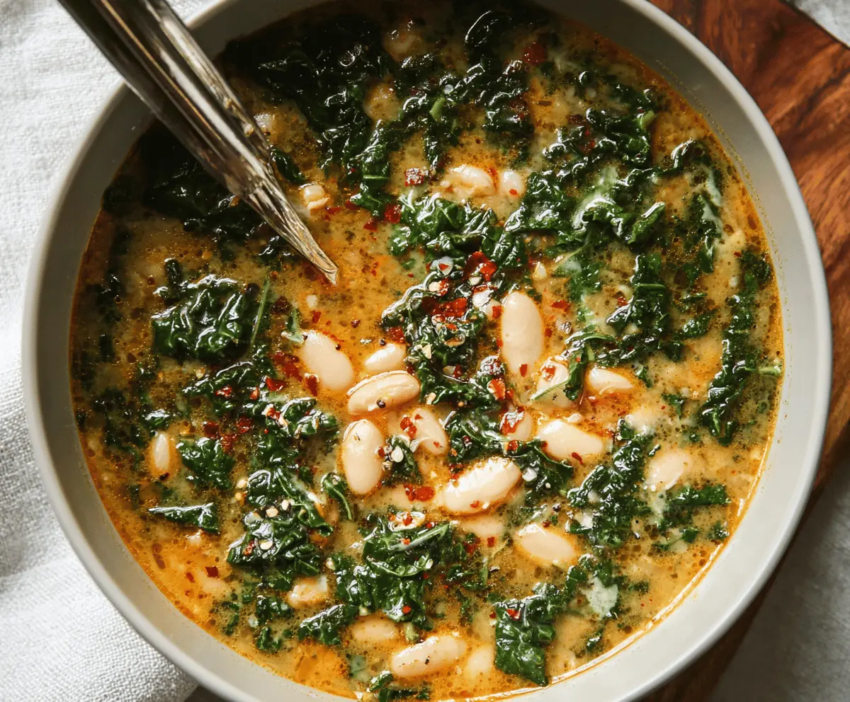 A bowl of hearty white bean and kale soup garnished with fresh herbs, showcasing a comforting, healthy meal with white beans, vibrant kale, and colorful vegetables.