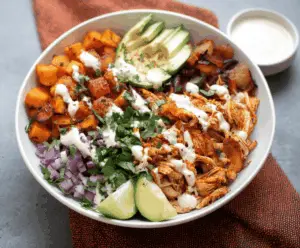 Delicious pulled chicken served in sweet potato bowls, garnished with fresh herbs for a healthy meal.