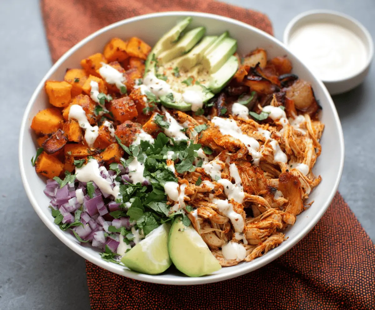 Delicious pulled chicken served in sweet potato bowls, garnished with fresh herbs for a healthy meal.