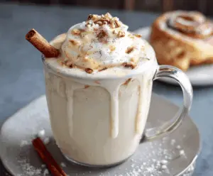 Creamy Cinnamon Bun White Hot Chocolate topped with whipped cream and cinnamon, perfect for cozy winter evenings.