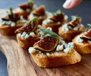 Delicious fig and blue cheese crostini with fresh figs and crumbled blue cheese on toasted baguette slices.