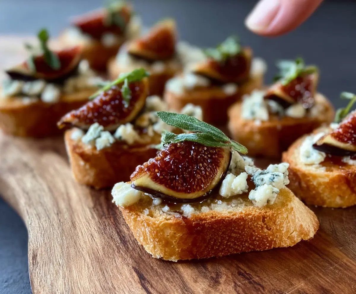 Delicious fig and blue cheese crostini with fresh figs and crumbled blue cheese on toasted baguette slices.