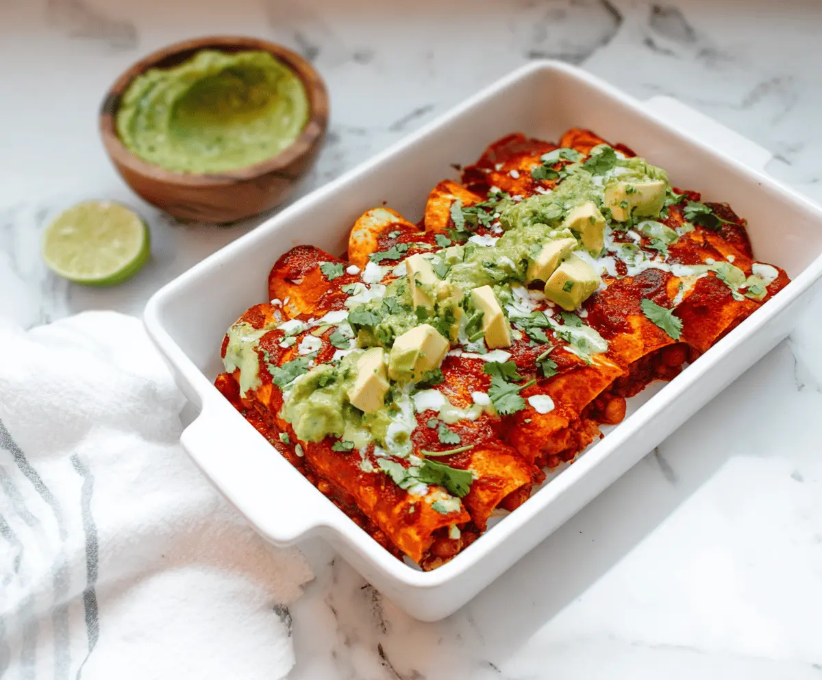 Delicious sweet potato and chickpea enchiladas topped with melted cheese and fresh cilantro.
