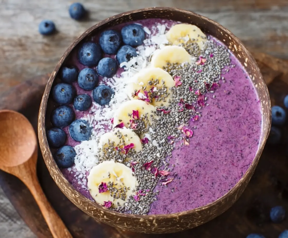 Vibrant blueberry smoothie bowl topped with fresh blueberries and granola, perfect for a healthy breakfast.