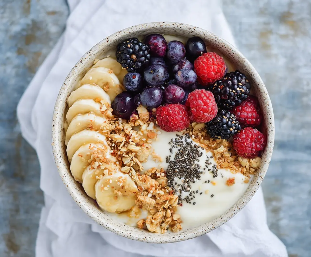 Healthy protein yogurt bowl topped with fresh berries and nuts, perfect for a nutritious breakfast.