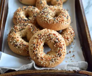Delicious homemade almond flour Greek yogurt bagels on a wooden surface, perfect for a healthy breakfast.