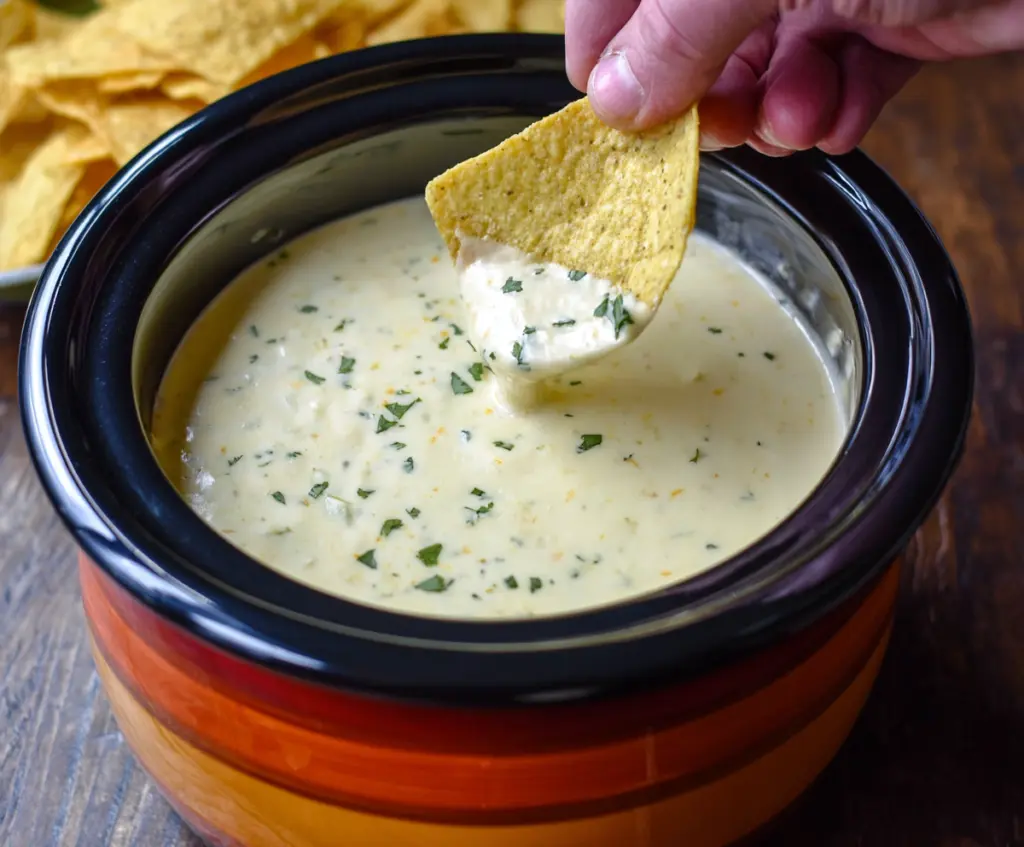 Creamy Crock Pot Queso Blanco Dip served in a bowl with tortilla chips for a savory appetizer.