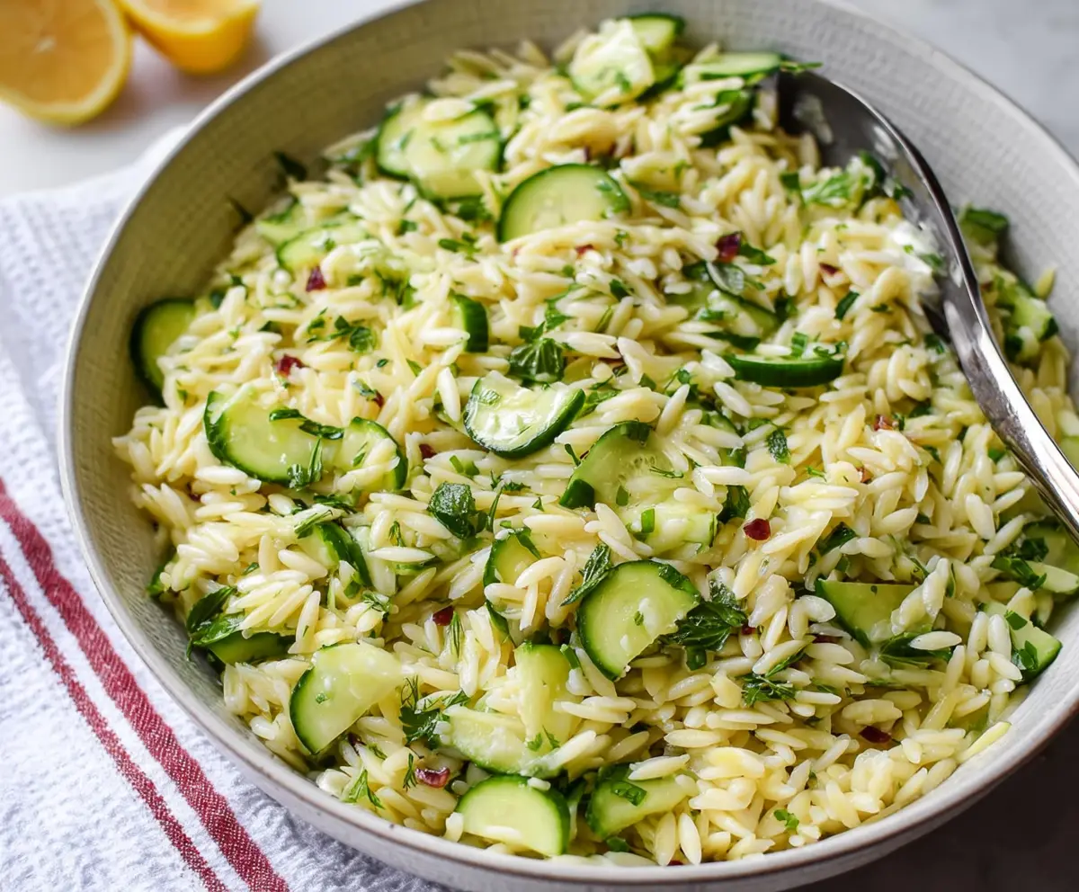 Fresh cucumber and lemon orzo salad served in a bowl for a light and refreshing meal.