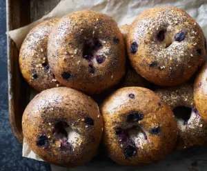 Delicious homemade sourdough blueberry bagels on a rustic wooden table.