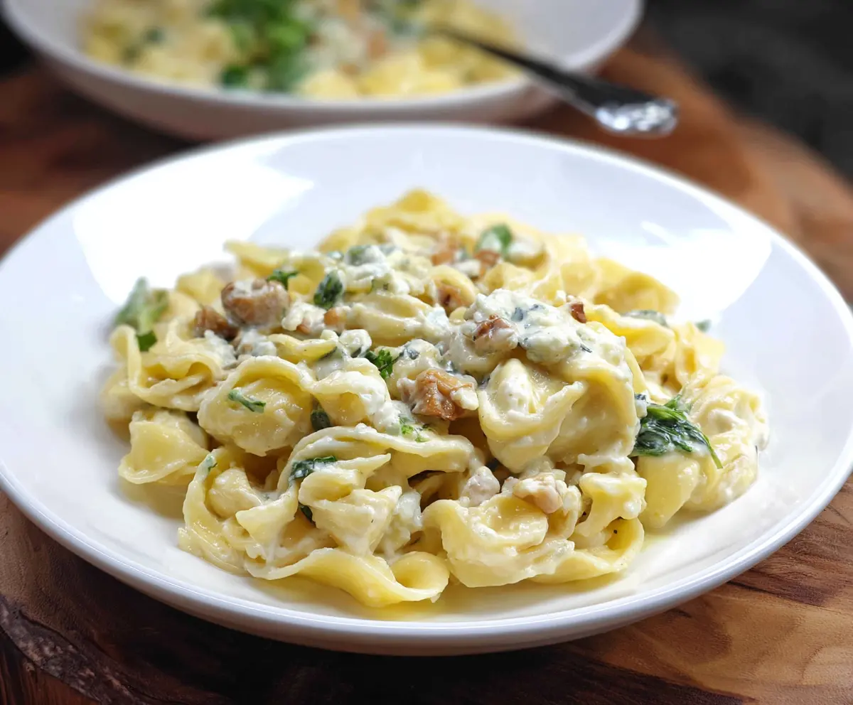 Creamy blue cheese pasta garnished with fresh herbs for a rich flavor.