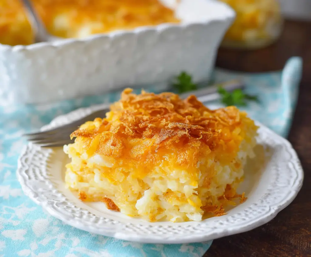 Delicious cheesy hashbrown casserole topped with melted cheese and crispy edges, perfect for family dinners.