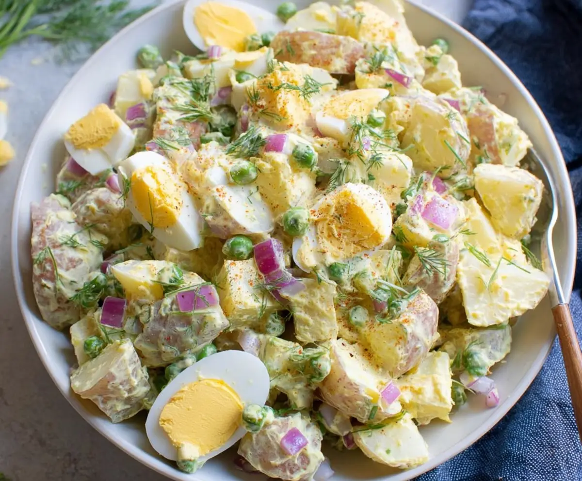 Bright Easter Potato Salad with colorful vegetables and fresh herbs in a festive bowl.