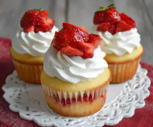Delicious strawberry shortcake cupcakes topped with whipped cream and fresh strawberries