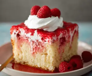 Delicious Raspberry Poke Cake with fresh raspberries and a moist, sweet sponge layer