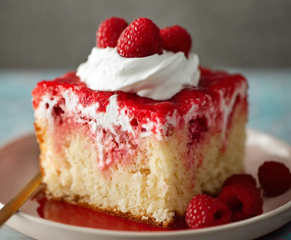 Delicious Raspberry Poke Cake with fresh raspberries and a moist, sweet sponge layer